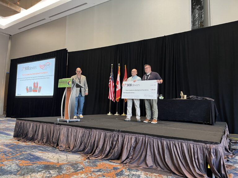 Michael Hildebrabd, YLD President, accepts donation from David Massingham of 908 Devices at IAFC HazMat Conference.